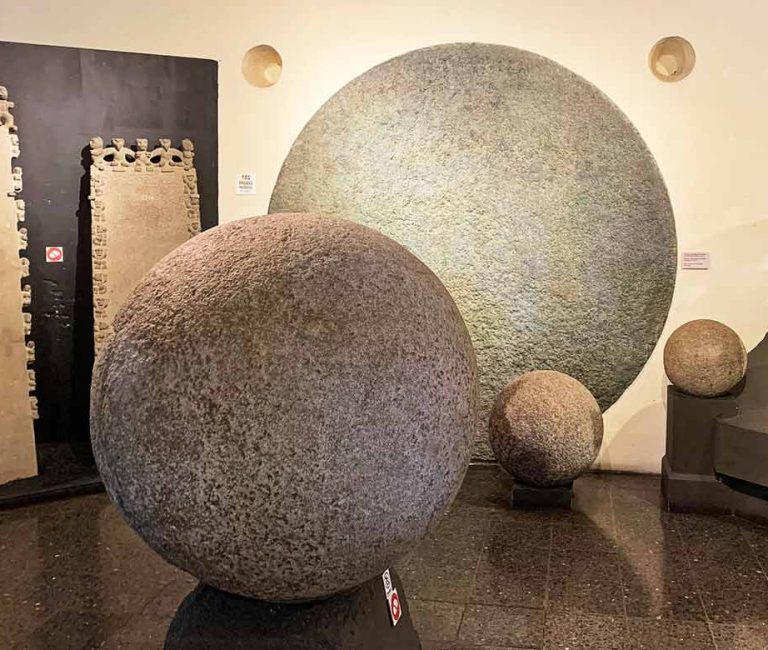 Several stone spheres of the Diquís exhibited at Museo Nacional de Costa Rica. For comparison purpose, the image on the wall shows the diameter of the biggest recorded stone sphere, 2.66 metres (8.7 ft) - taken from wikipedia